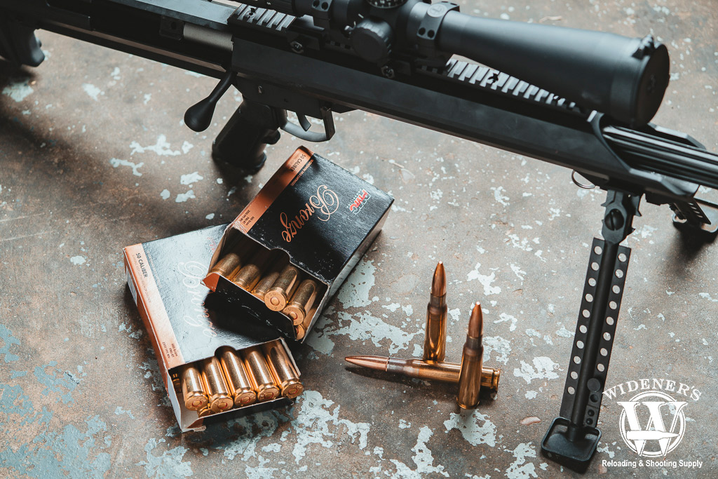 PMC .50 BMG ammo with a bolt action rifle a photo of PMC .50 BMG ammo with a bolt action rifle