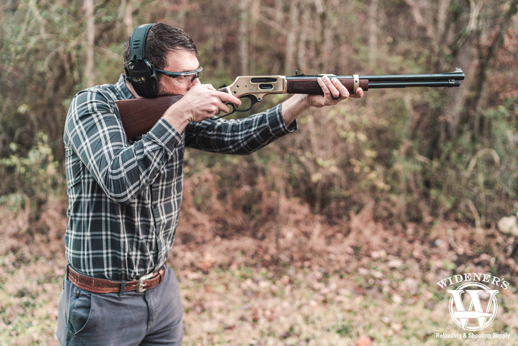 man shooting a lever action rifle a photo of a man shooting a lever action rifle