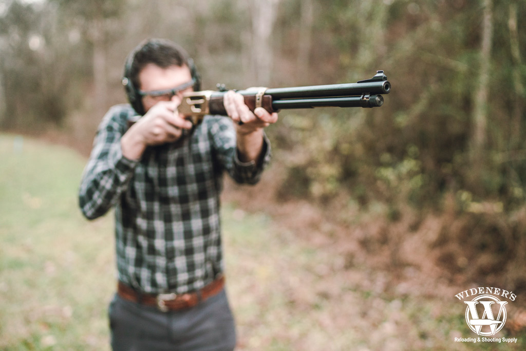 shooting a 30-30 lever action rifle a photo of a man shooting a 30-30 lever action rifle