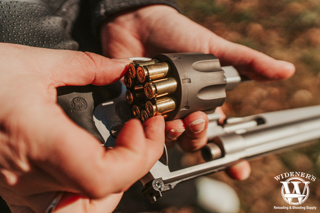 revolver being loaded with a moon clip a photo of a revolver being loaded with a moon clip