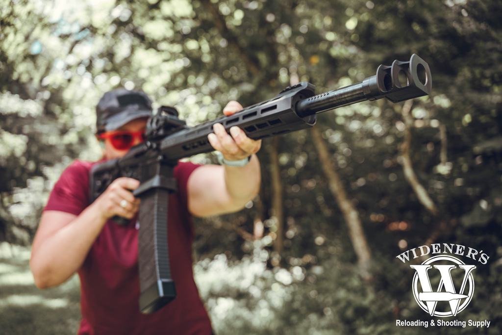 woman shooting a 12-gauge mag fed shotgun a photo of a woman shooting a 12-gauge mag fed shotgun