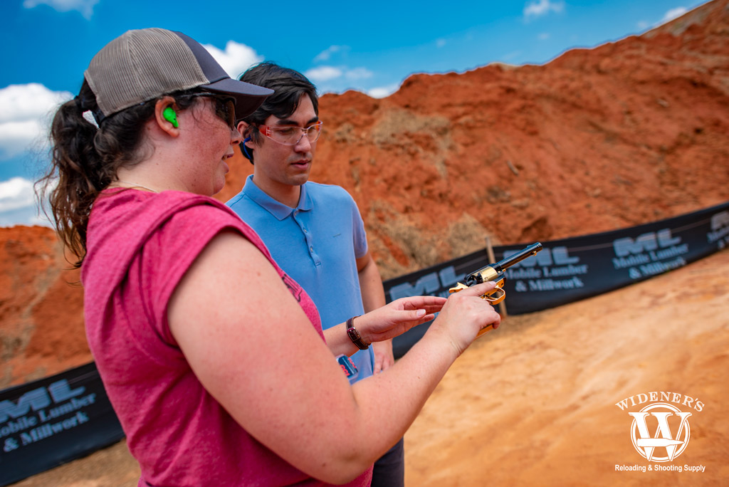 female instructor teaching conceal and carry classes outdoors with revolver pistol a female instructor teaching conceal and carry classes outdoors with revolver pistol