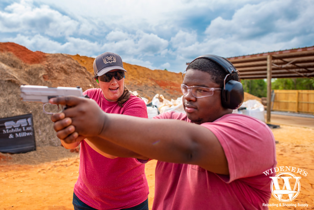 an african american male shooting at an outdoor pistol range a photo of an african american male shooting at an outdoor pistol range