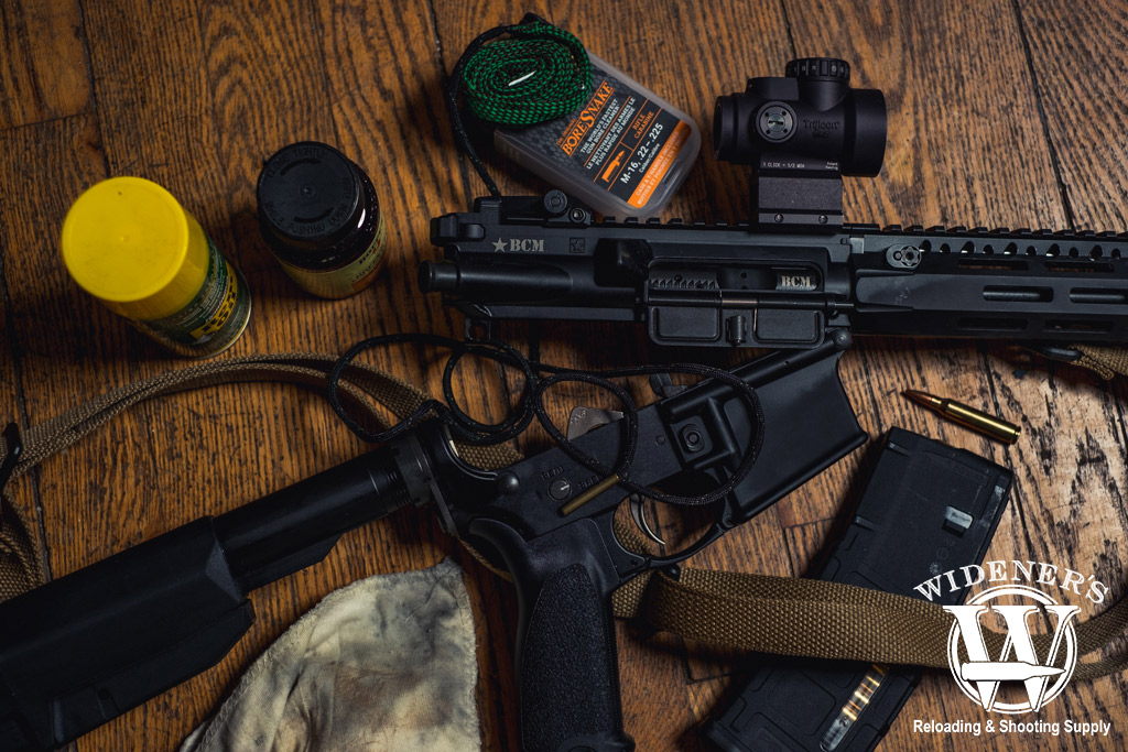 a photo of an ar-15 rifle disassembled for cleaning