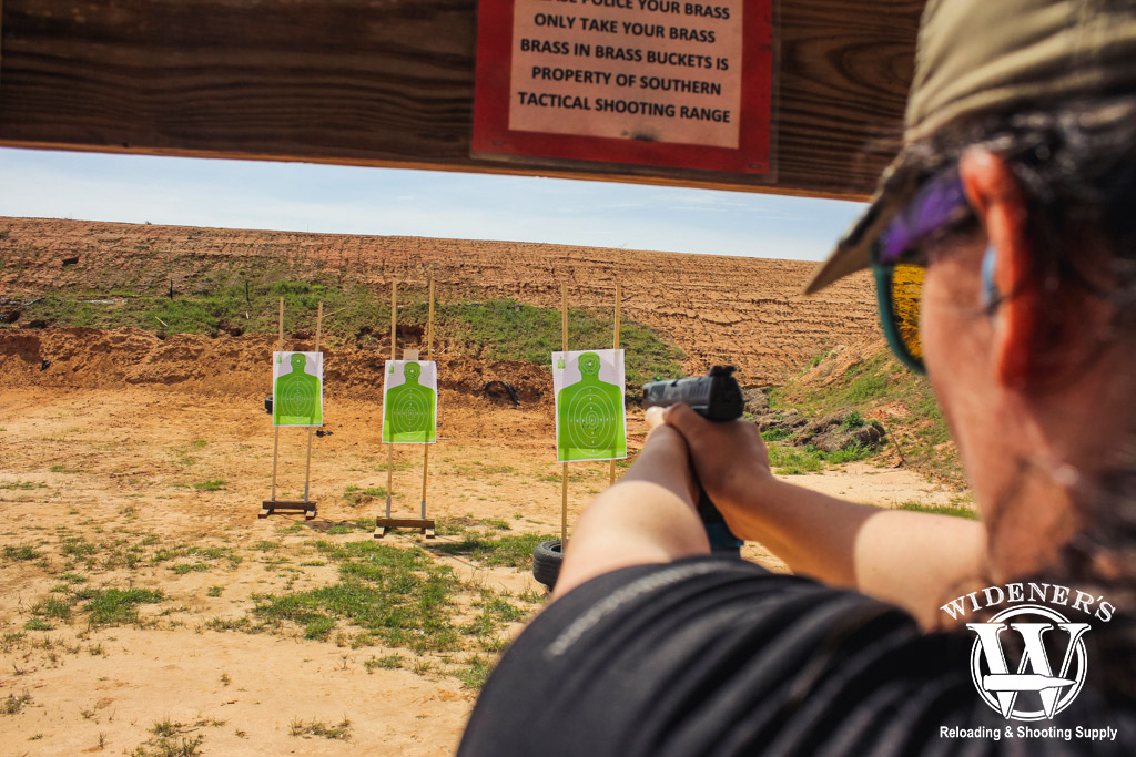 female shooting at targets at an outdoor shooting range a photo of a female shooting at targets at an outdoor shooting range