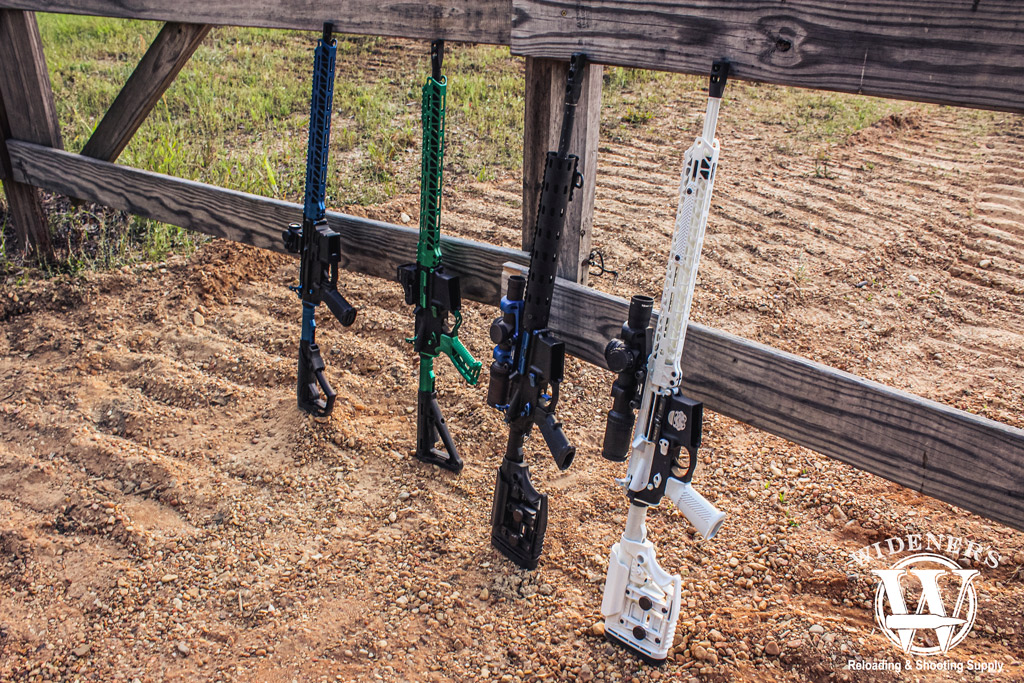ar-15 rifles leaning up against a fence a photo of ar-15 rifles leaning up against a fence