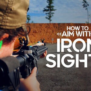 a photo of a female shooter showing how to aim with iron sights