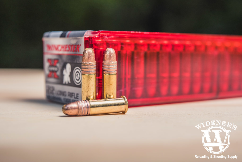 the .22 LR is a popular choice for many shooters because of its versatility photo of winchester .22 LR ammo sitting outside on a sheet of plywood