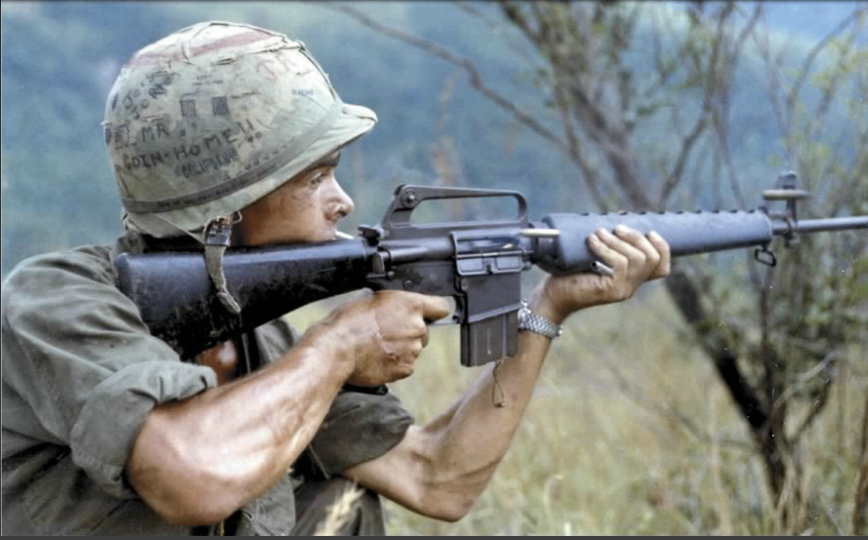 vietnam war US soldier firing an m16 rifle photo of vietnam war US soldier firing an m16 rifle