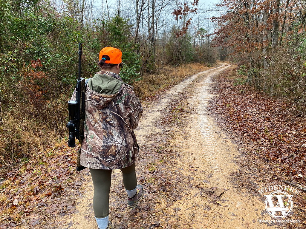 a female hunter in the woods a photo of a female hunter in the woods