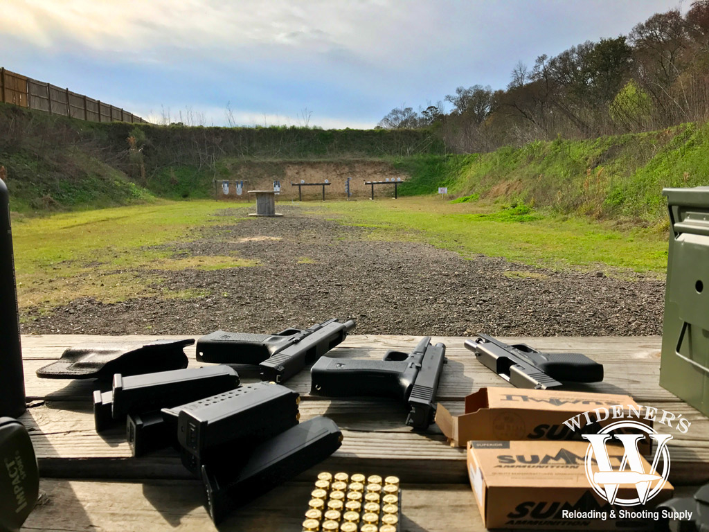 table at a gun range with glock pistols a photo of a table at a gun range with glock pistols sitting on it
