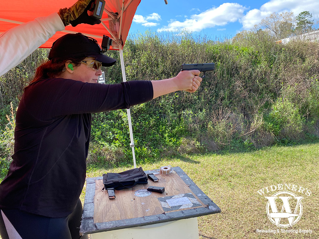 female shooting a glock handgun outside photo of a female shooting a glock handgun outside