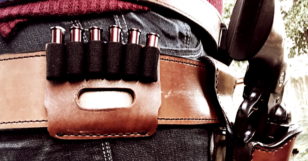 A leather slide with 5 bullet loops for holding rifle ammo at a Cowboy Action Stage a photo of A leather slide with 5 bullet loops for holding rifle ammo at a Cowboy Action Stage