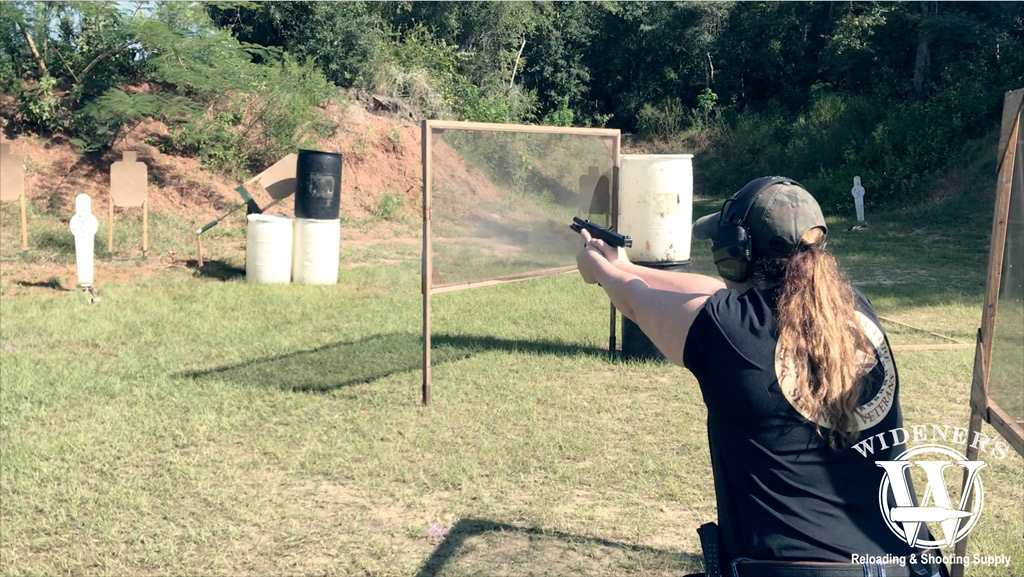 female competition shooting a pistol at a match a photo of a female competition shooting a pistol at a match