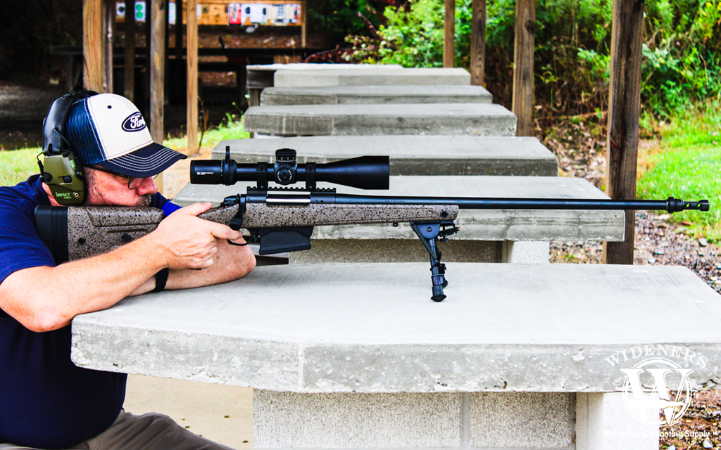 man shooting a .300 Winchester Magnum bolt action rifle a photo of a man shooting a .300 Winchester Magnum bolt action rifle