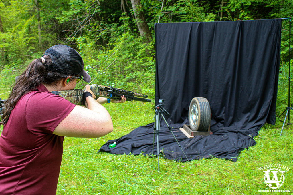 a woman with a shotgun outdoors a photo of a woman with a shotgun outdoors