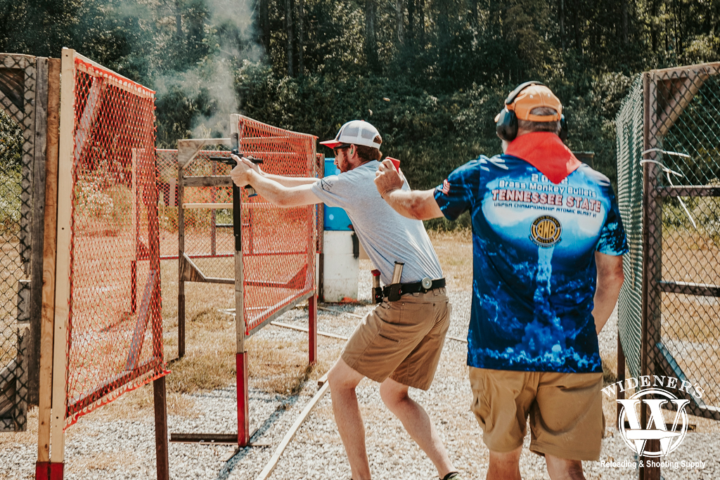 a man shooting in a USPSA competition a photo of a man shooting in a USPSA competition