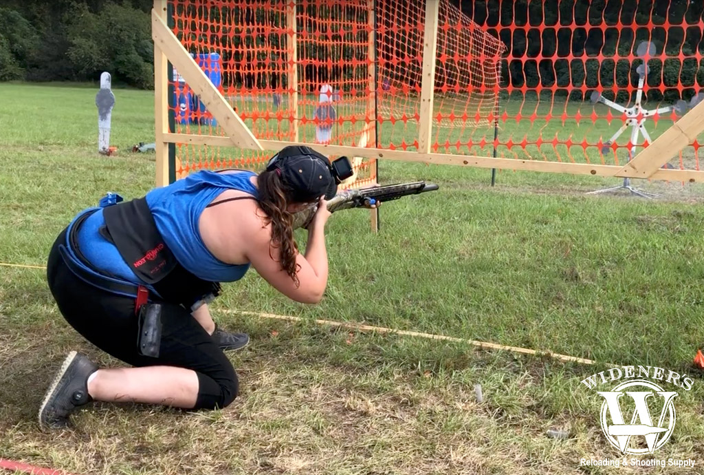 Kenzie shooting a shotgun at a revolving target a photo of Kenzie shooting a shotgun at a revolving target