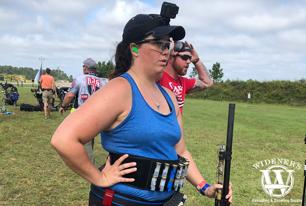 female 3 gun competition competitor with a 12 gauge shotgun a photo of a female 3 gun competition competitor with a 12 gauge shotgun
