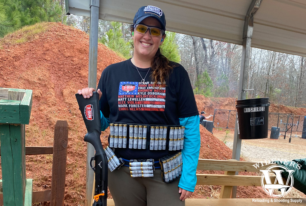 3 gun competition shooter with 12 gauge shotgun a photo of a female 3 gun competition shooter with 12 gauge shotgun