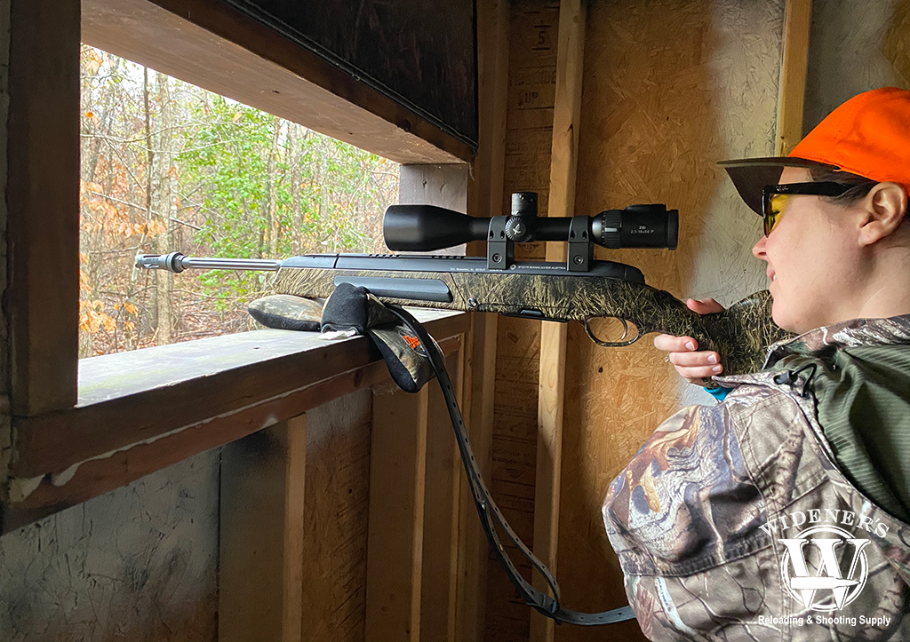 a photo of a female hunter showing the best time of day to hunt deer