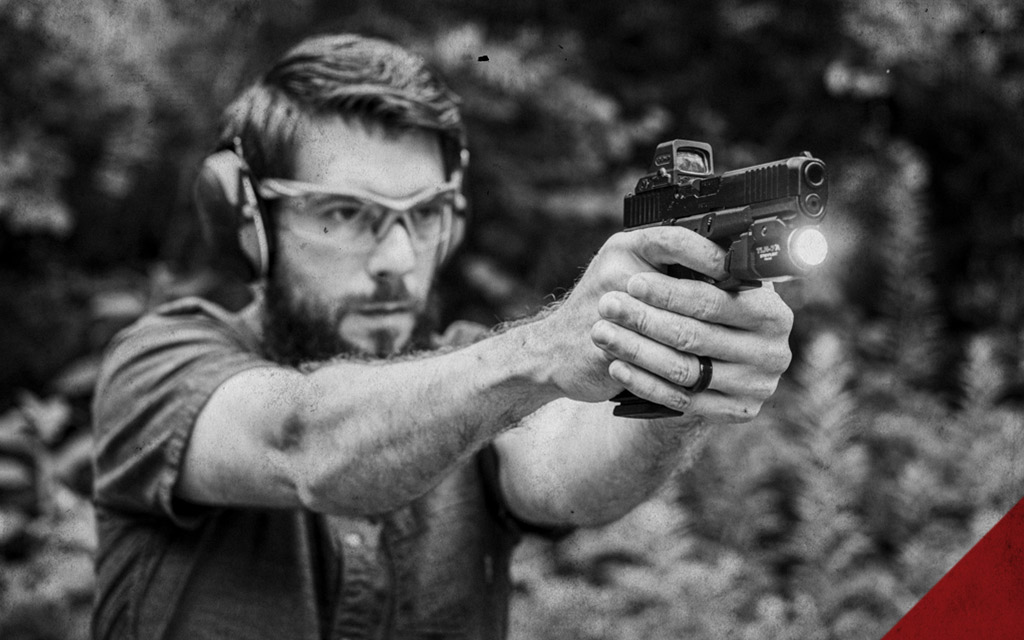 a man shooting a glock handgun a photo of a man shooting a glock handgun