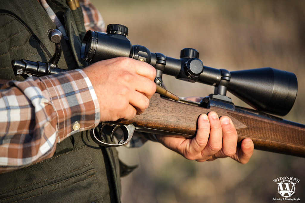 man reloading a rifle a photo of a man reloading a rifle