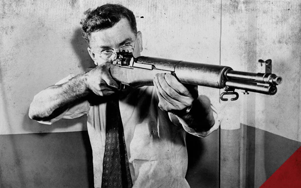 John C. Garand holding his invention a historical photo of John C. Garand holding his invention