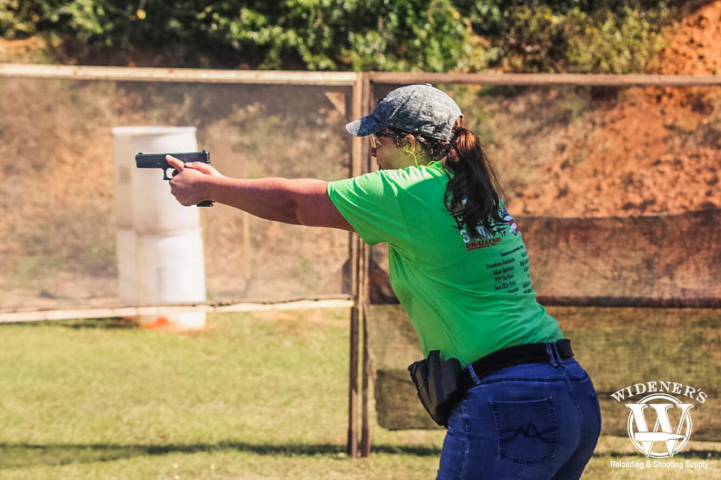 female competition shooter a female competition shooter running at a gun range