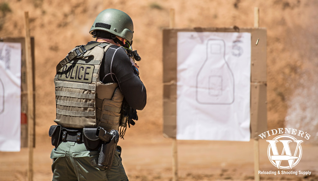 police officer shooting a rifle at an outdoor gun range a photo of a police officer shooting a rifle at an outdoor gun range
