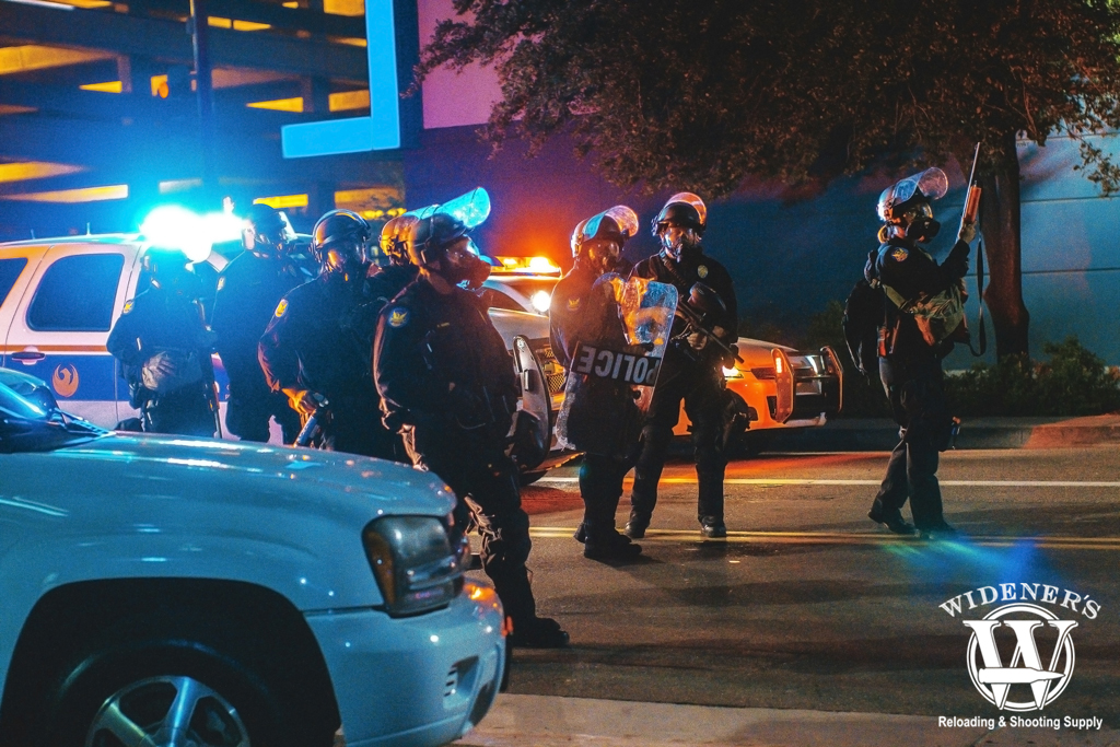 a photo of police in riot gear